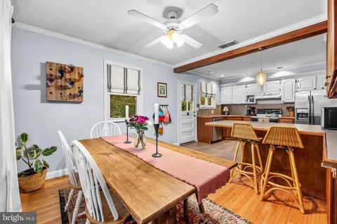 a view of a dining room with furniture and a kitchen