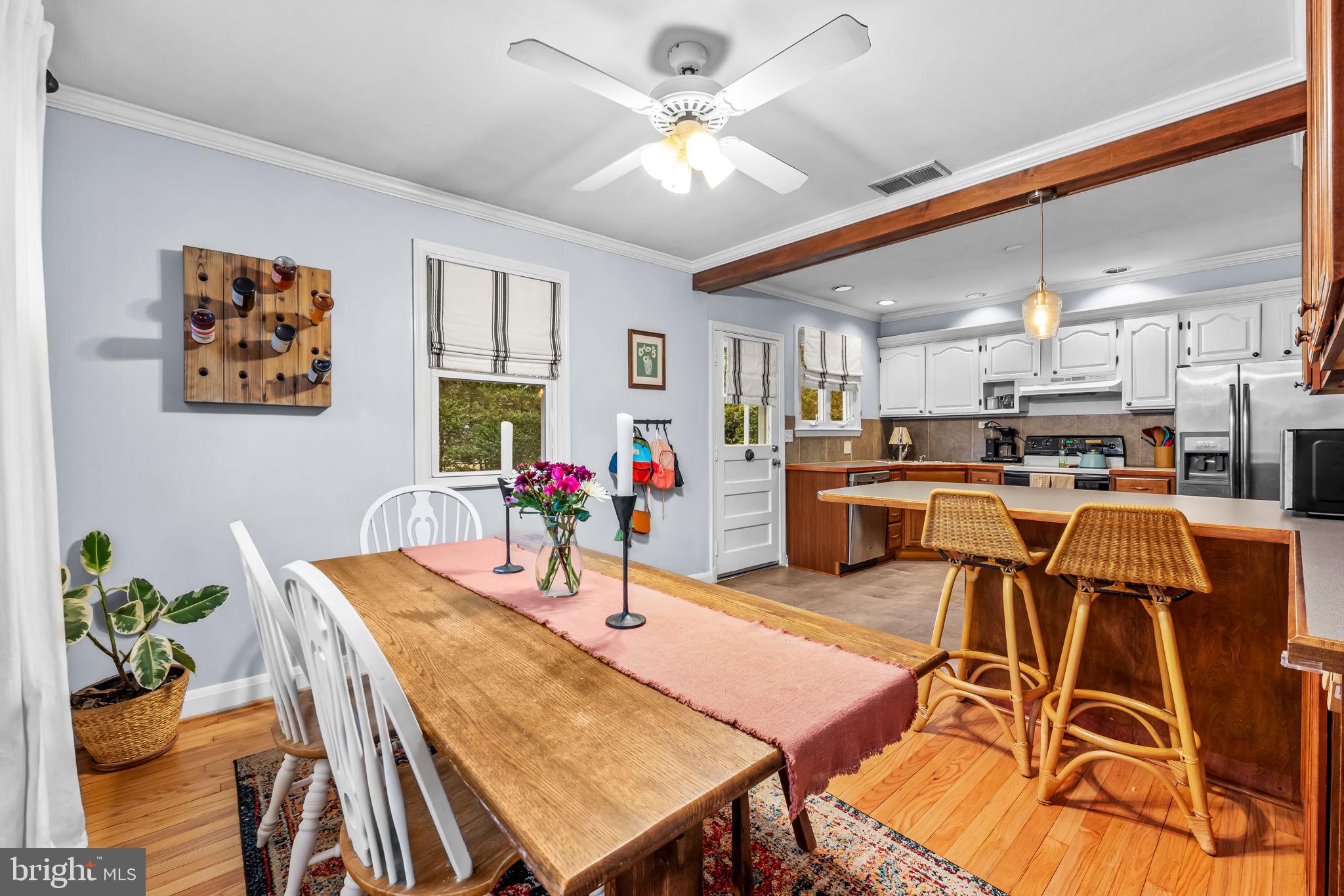 6745 Glenkirk Road Baltimore, MD 21239 - Photo 8 of 35 a view of a dining room with furniture and a kitchen