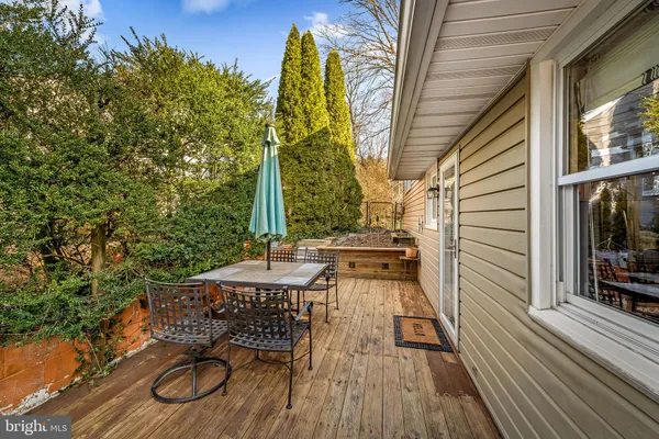 a view of balcony with wooden floor and outdoor seating