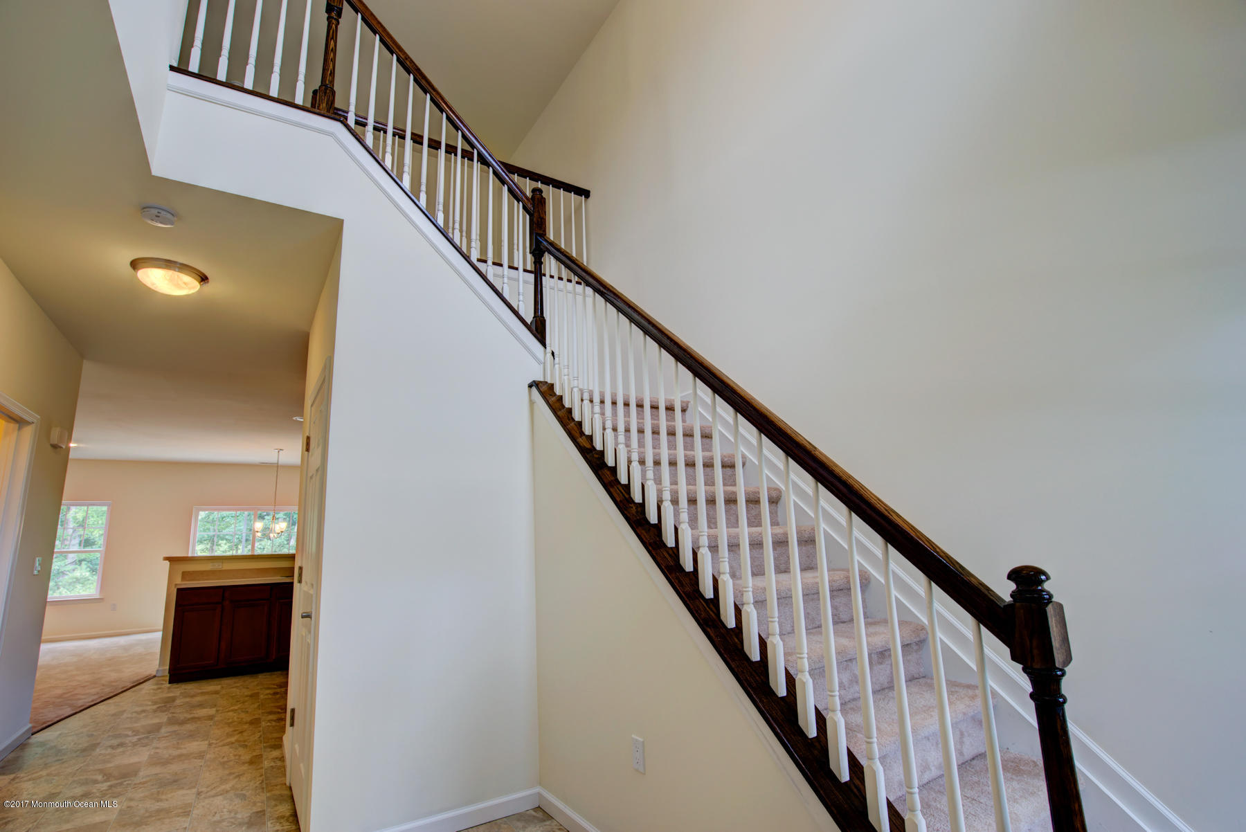 57 Rockingham Way Manchester Township, NJ 08759 - Photo 4 of 17 a view of staircase with wooden floor and a kitchen