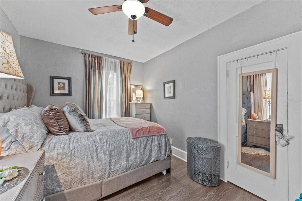 1326 17th Terrace North St. Petersburg, FL 33704 - Photo 11 of 28 a bedroom with a large bed and a chandelier