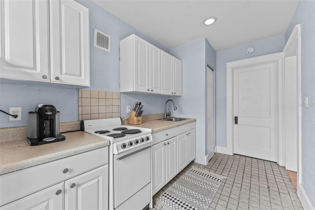 1326 17th Terrace North St. Petersburg, FL 33704 - Photo 19 of 28 a kitchen with granite countertop a sink stove and cabinets