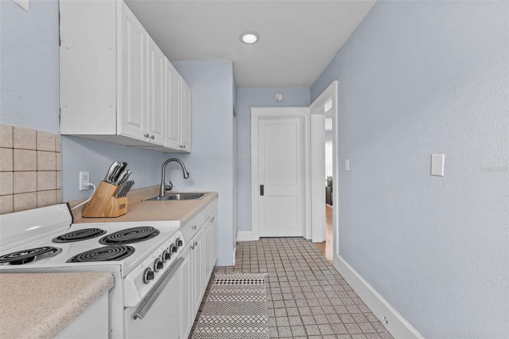 1326 17th Terrace North St. Petersburg, FL 33704 - Photo 20 of 28 a kitchen with a stove and a refrigerator