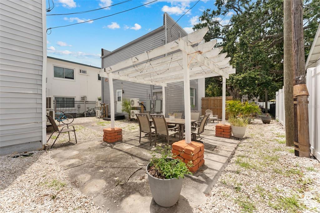 1326 17th Terrace North St. Petersburg, FL 33704 - Photo 25 of 28 a view of a patio with couches table and chairs and potted plants