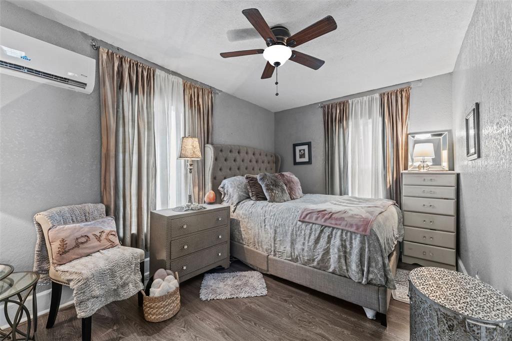 1326 17th Terrace North St. Petersburg, FL 33704 - Photo 10 of 28 a bedroom with a bed chandelier and a window