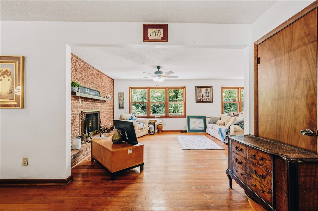 707 Campbell Town Road Walhalla, SC 29691 - Photo 10 of 44 Gleaming hardwood floors and a brick fireplace define this inviting open living space.