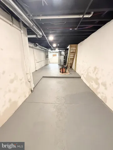 a utility room with wooden floor washer and dryer