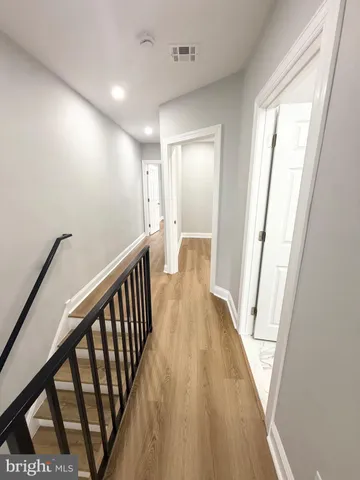 a white toilet sitting next to a bathroom sink and a mirror