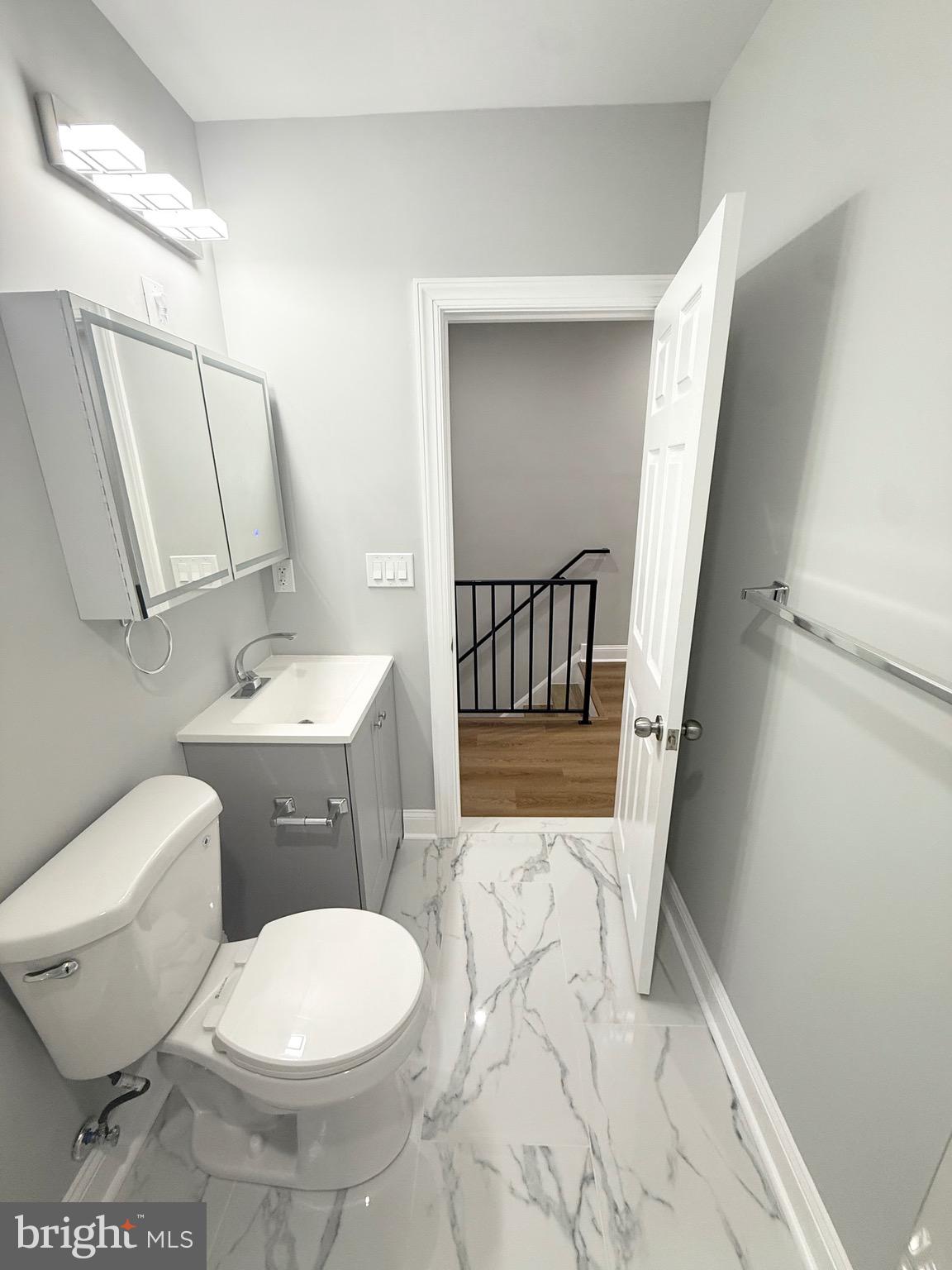 355 East Loudon Street Philadelphia, PA 19120 - Photo 23 of 30 a white toilet sitting next to a bathroom sink and a mirror