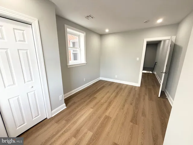 a bedroom with a bed window and couch