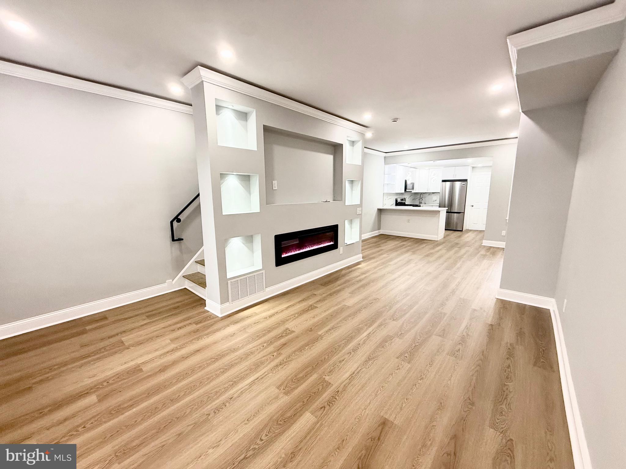 355 East Loudon Street Philadelphia, PA 19120 - Photo 5 of 30 a view of a livingroom with wooden floor and a fireplace