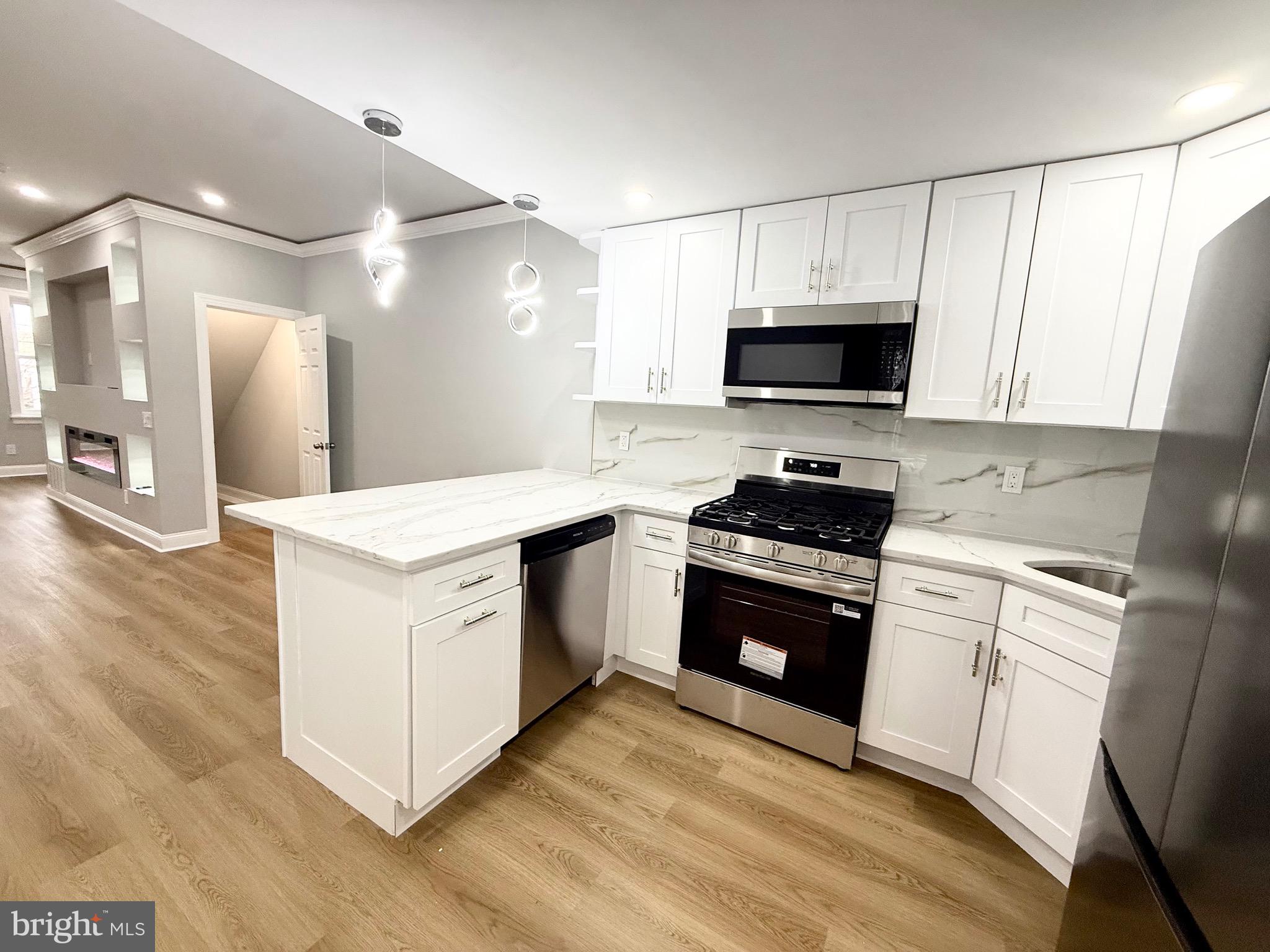 355 East Loudon Street Philadelphia, PA 19120 - Photo 8 of 30 a kitchen with a stove and a microwave