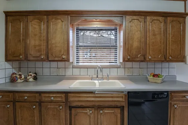 a view of a kitchen with a sink and cabinets