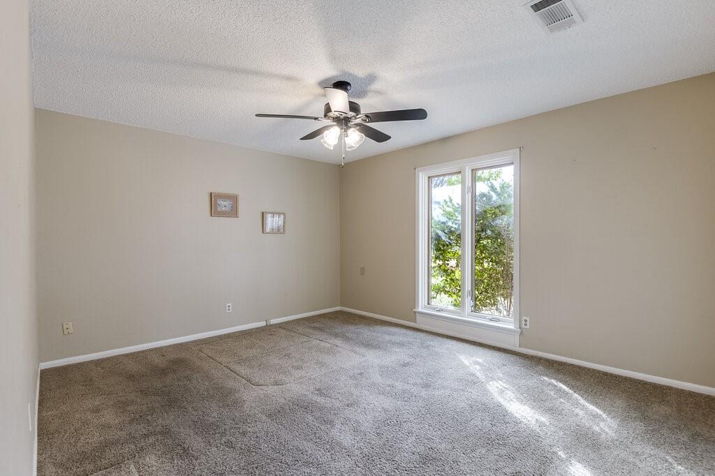 1609 Delta Drive Arlington, TX 76012 - Photo 21 of 28 an empty room with windows and fan