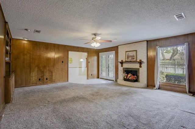 a view of an empty room with a fireplace