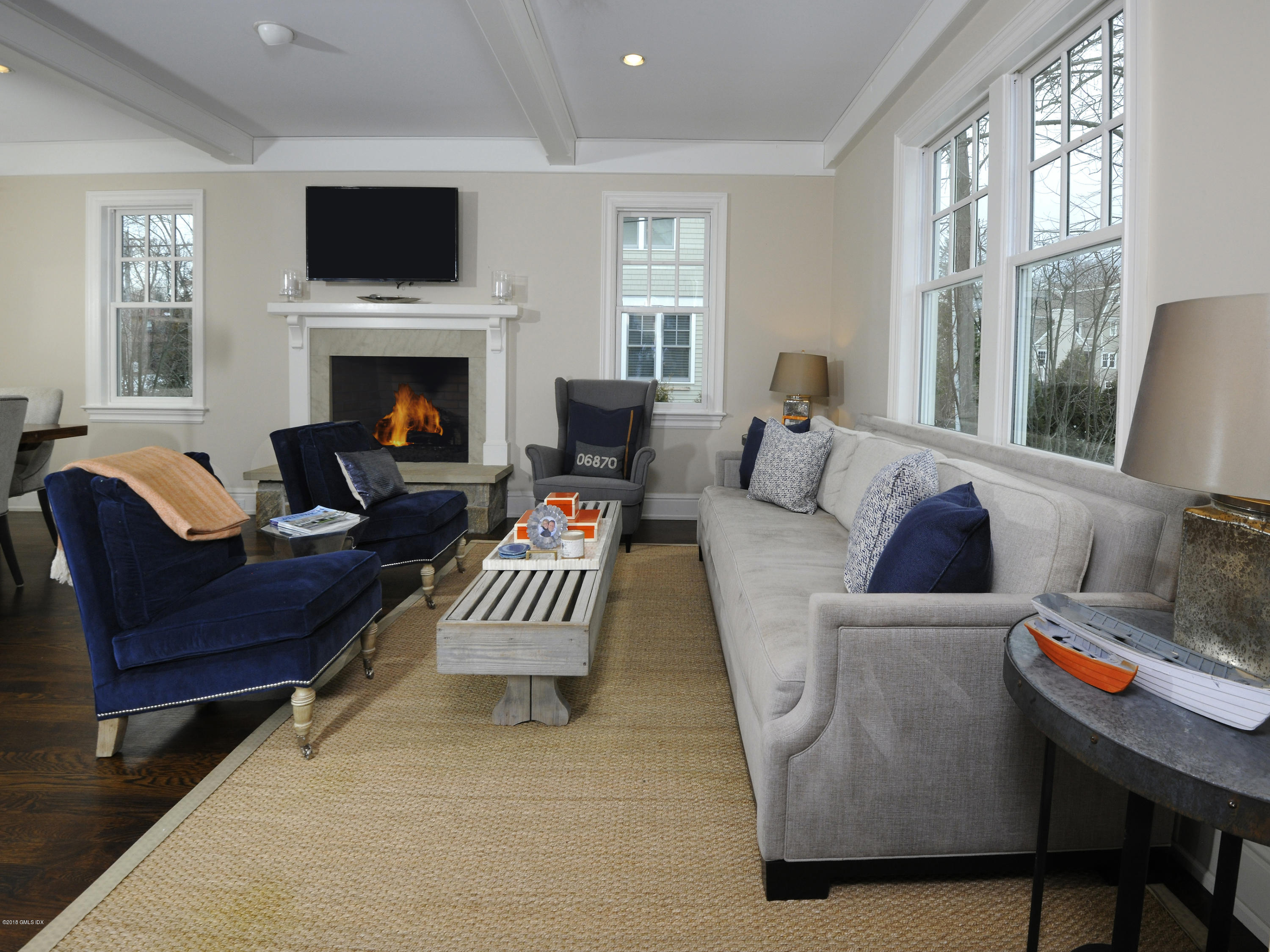 12 Ledge Road Old Greenwich, CT 06870 - Photo 12 of 34 a living room with furniture a flat screen tv and a fireplace