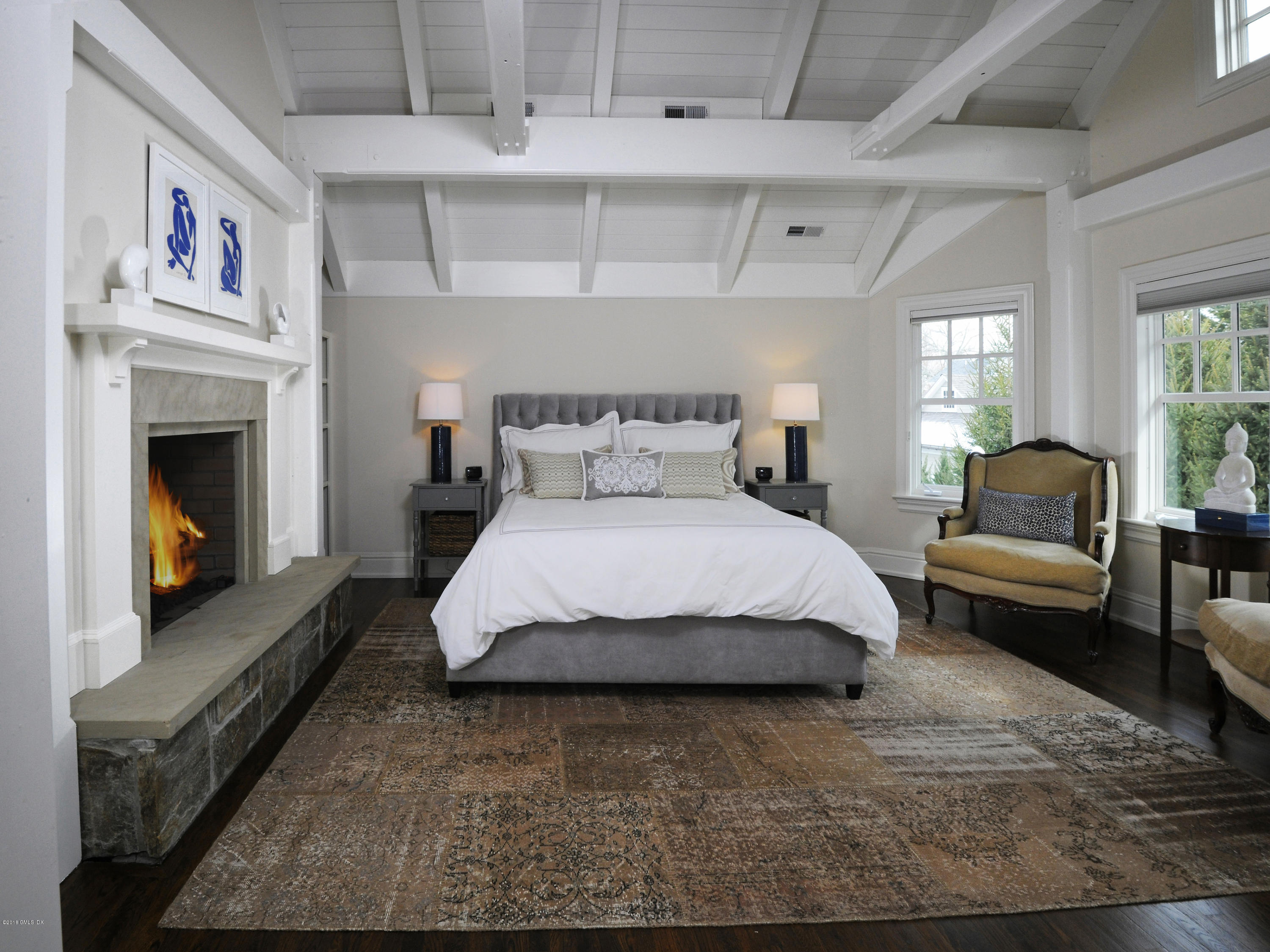 12 Ledge Road Old Greenwich, CT 06870 - Photo 15 of 34 a spacious bedroom with a bed a couch and a window