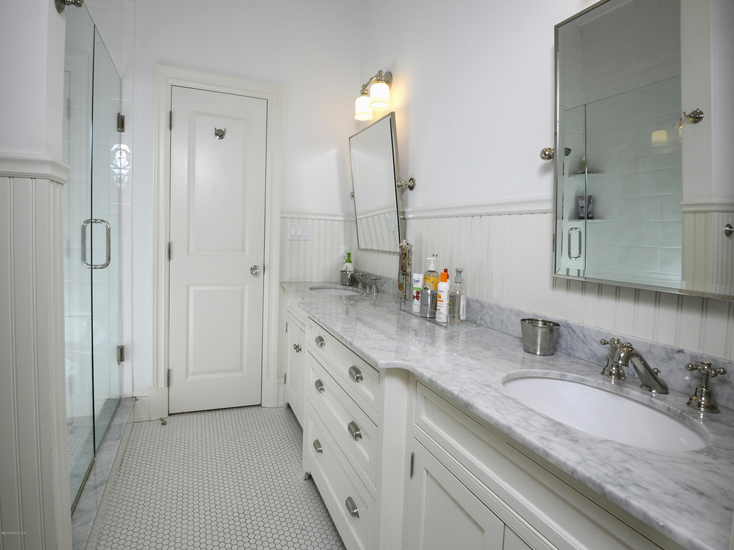 12 Ledge Road Old Greenwich, CT 06870 - Photo 21 of 34 a bathroom with double sink and a mirror