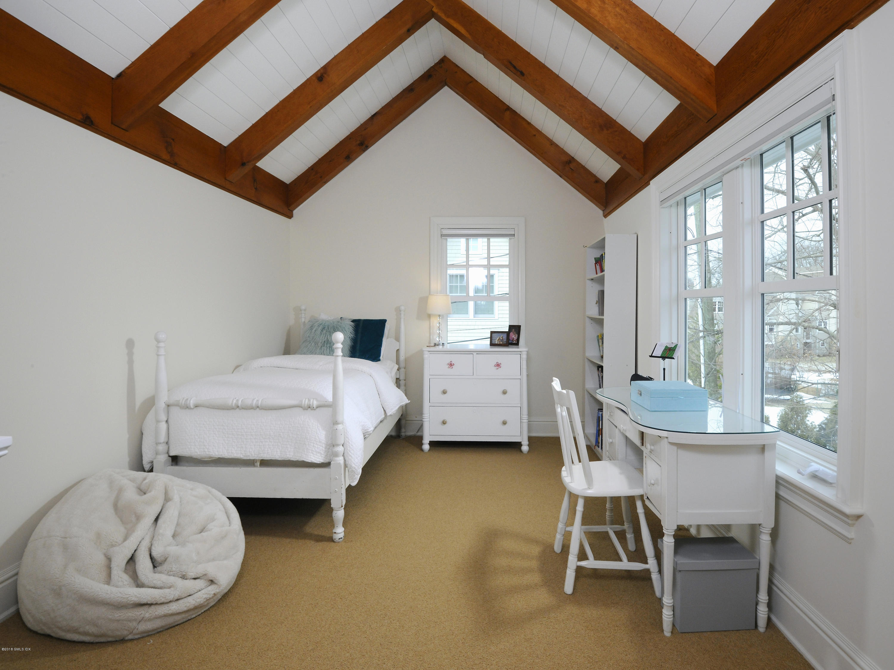 12 Ledge Road Old Greenwich, CT 06870 - Photo 23 of 34 a bedroom with a bed a table and chair