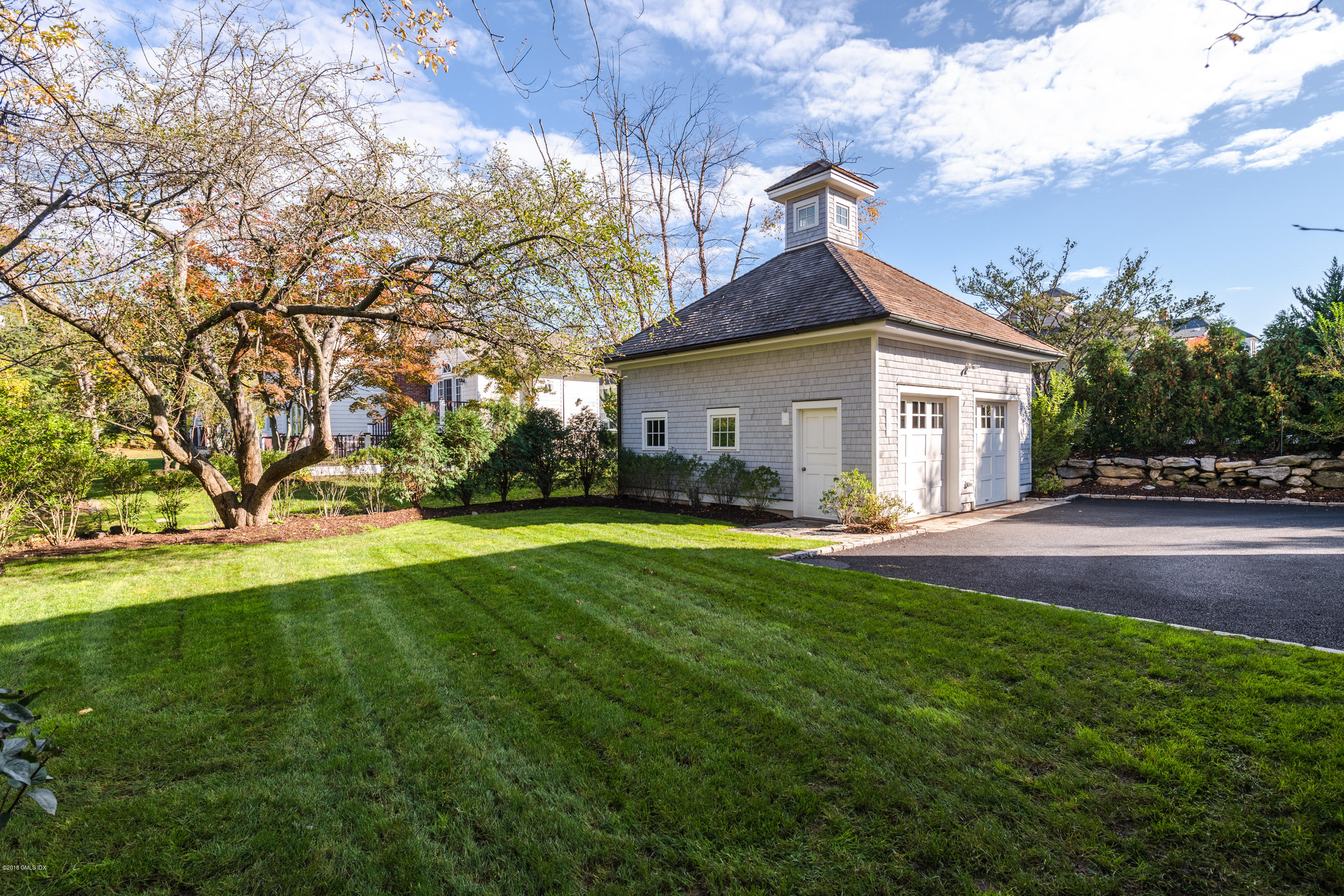 12 Ledge Road Old Greenwich, CT 06870 - Photo 26 of 34 a view of a white house in front of a big yard with large trees