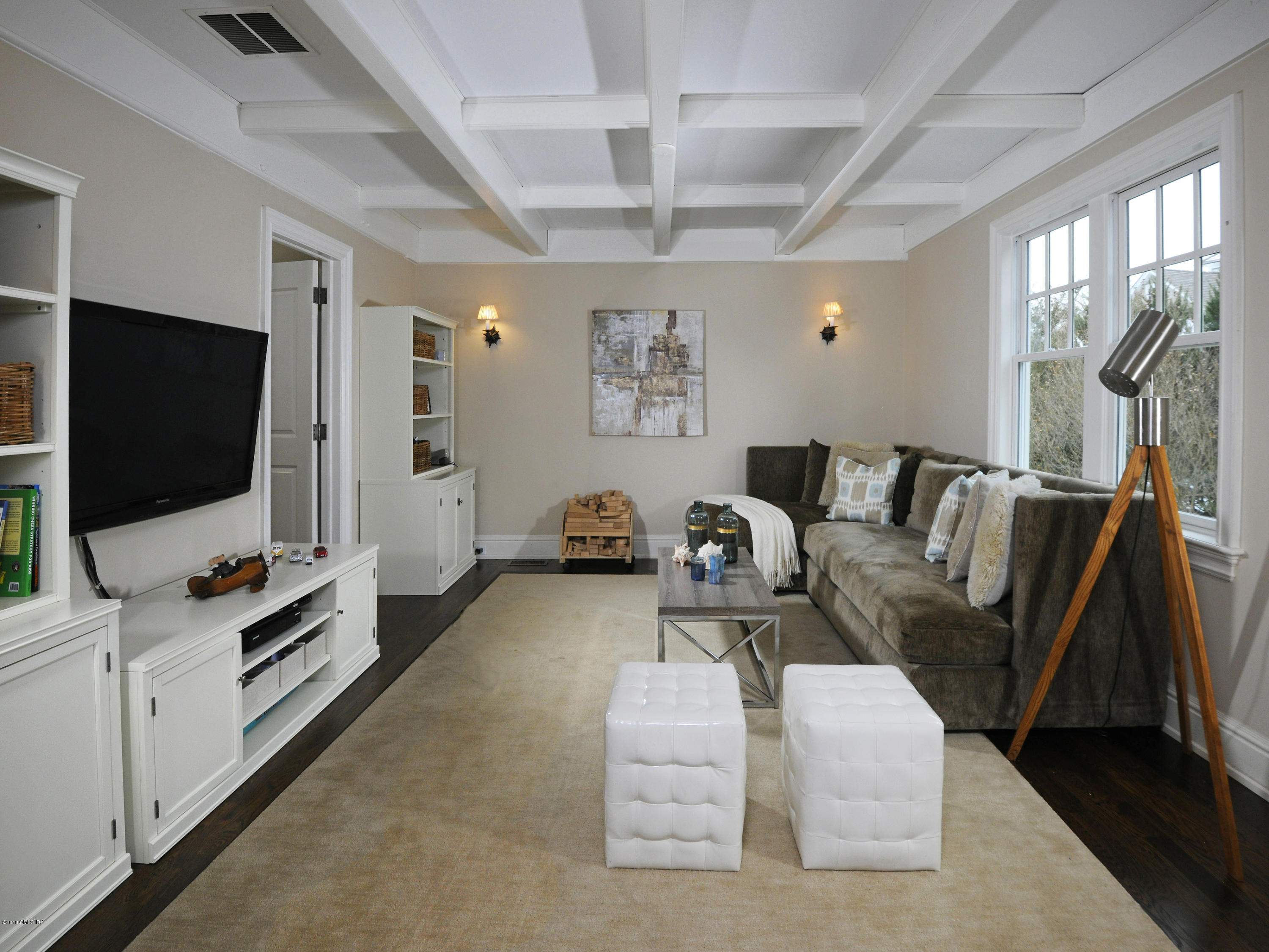 12 Ledge Road Old Greenwich, CT 06870 - Photo 8 of 34 a living room with furniture a flat screen tv and gym equipment