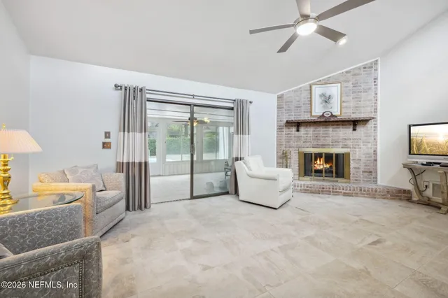 a living room with furniture and a fireplace