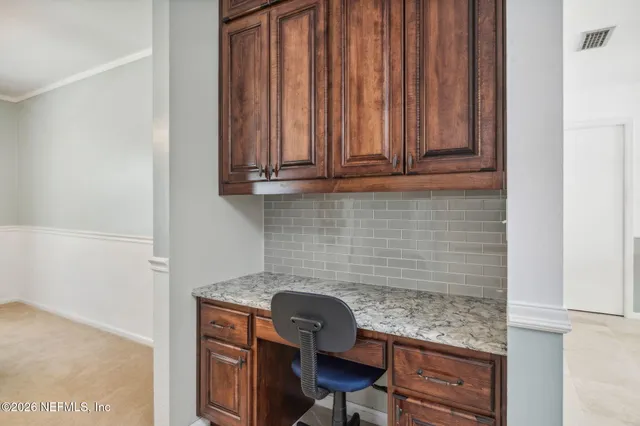 a kitchen with granite countertop white cabinets and white appliances