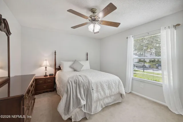 a bedroom with a bed and a painting on the wall