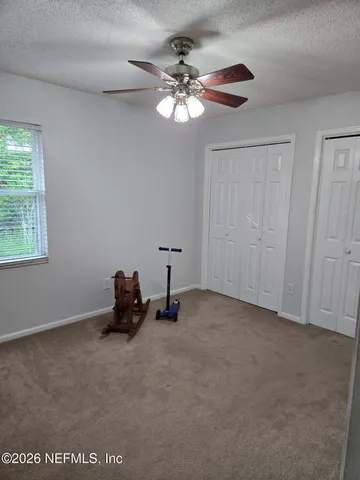 an empty room with a empty space and a ceiling fan