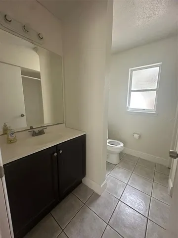 a bathroom with a toilet sink and a mirror