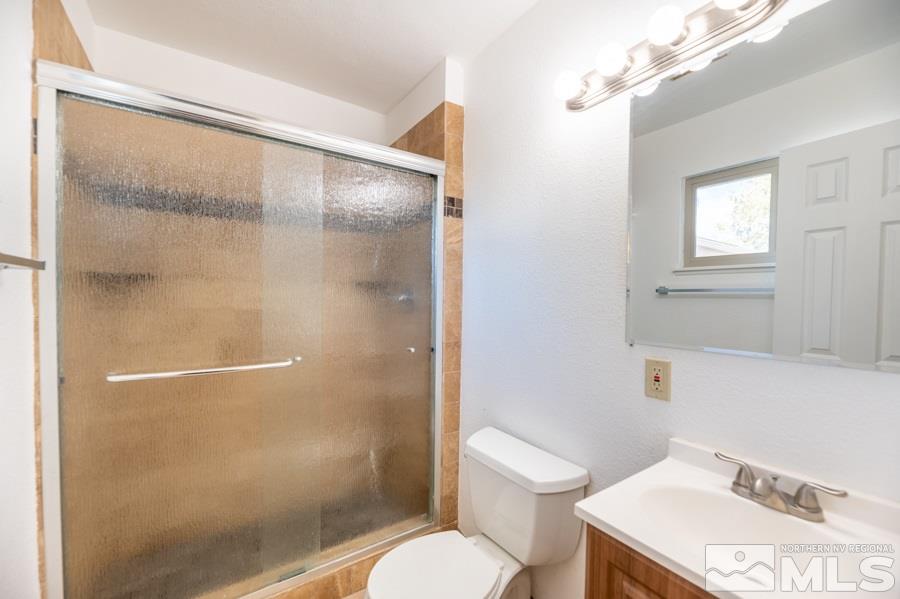 1355 Akard Drive Reno, NV 89503 - Photo 11 of 22 a white toilet sitting next to a bathroom sink