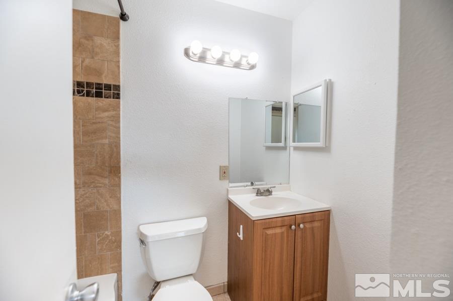 1355 Akard Drive Reno, NV 89503 - Photo 13 of 22 a bathroom with a toilet sink and mirror