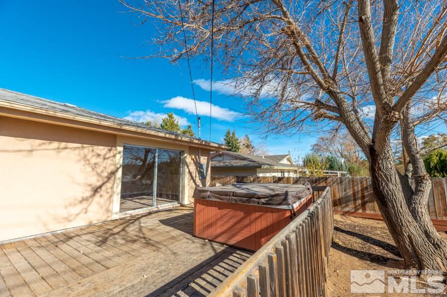 1355 Akard Drive Reno, NV 89503 - Photo 20 of 22 a view of a backyard with wooden fence and a large tree