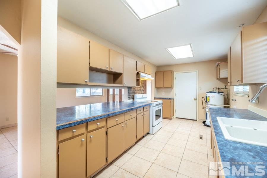 1355 Akard Drive Reno, NV 89503 - Photo 7 of 22 a kitchen with stainless steel appliances granite countertop a sink and cabinets
