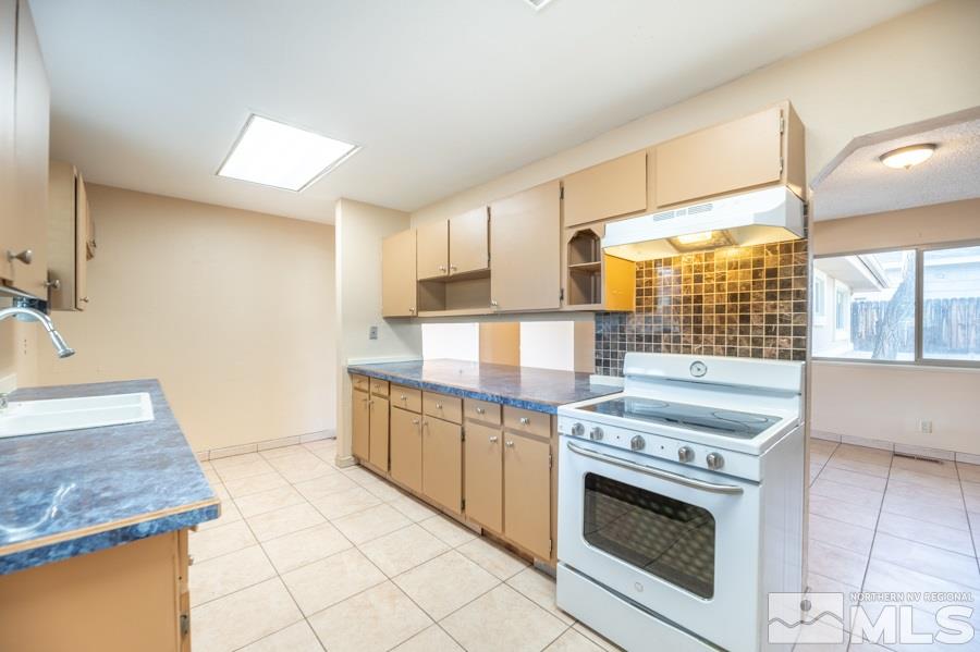 1355 Akard Drive Reno, NV 89503 - Photo 8 of 22 a kitchen with stainless steel appliances granite countertop a stove and a sink