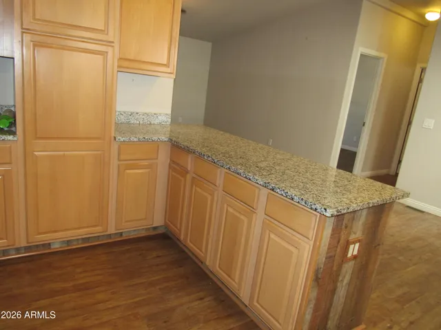 a kitchen with stainless steel appliances granite countertop a refrigerator a stove and a sink