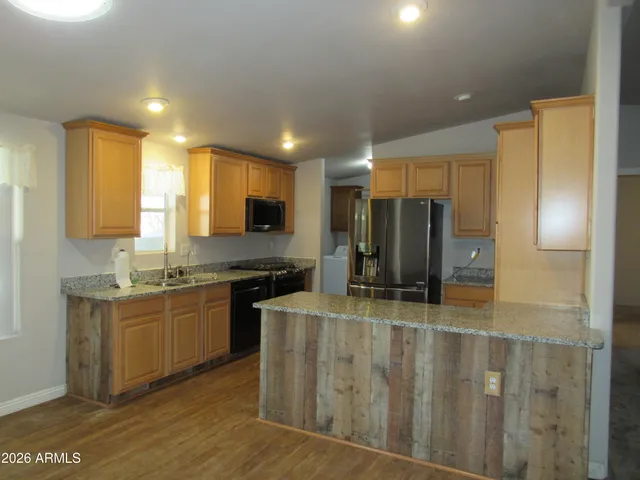 a kitchen with lots of counter top space and stainless steel appliances