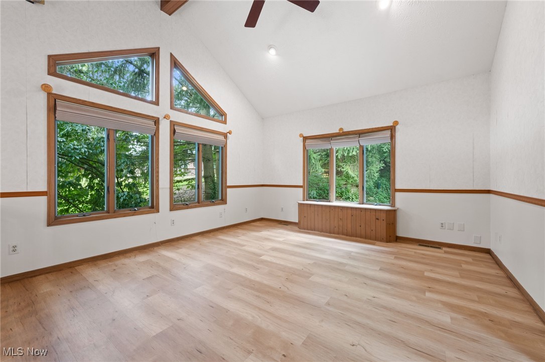 163 Burns Road Elyria, OH 44035 - Photo 13 of 37 Unfurnished room featuring beam ceiling, a ceiling fan, wood style floors, and high vaulted ceiling