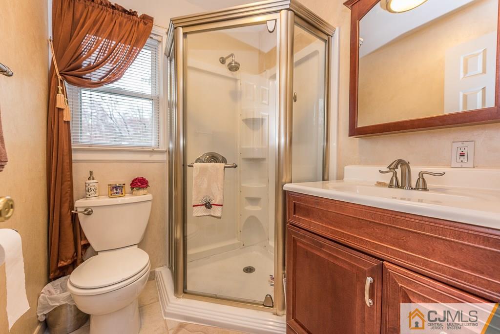 25 South Westfield Road Howell, NJ 07731 - Photo 12 of 22 a bathroom with a toilet a sink and a window