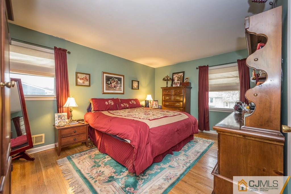 25 South Westfield Road Howell, NJ 07731 - Photo 13 of 22 a bedroom with a bed and wooden floor