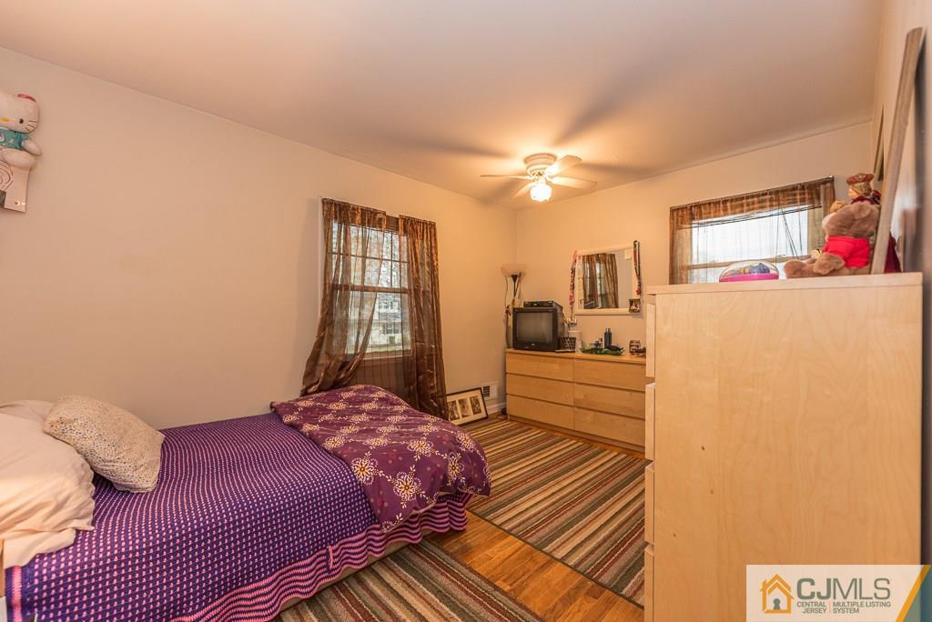 25 South Westfield Road Howell, NJ 07731 - Photo 14 of 22 a bedroom with a bed and a chandelier