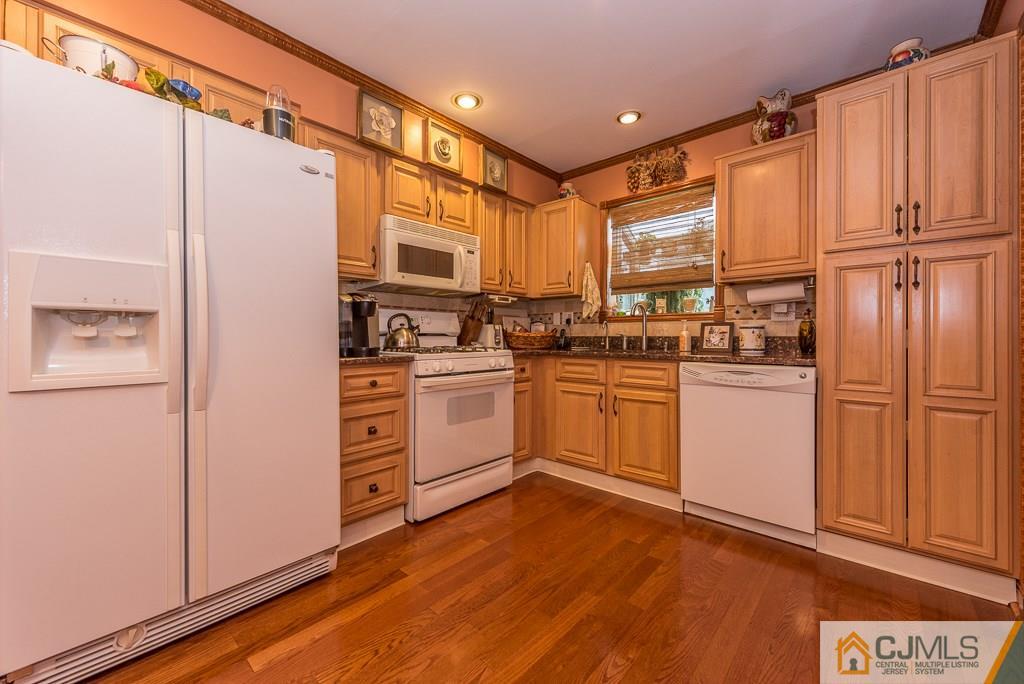 25 South Westfield Road Howell, NJ 07731 - Photo 6 of 22 a kitchen with white cabinets and white appliances