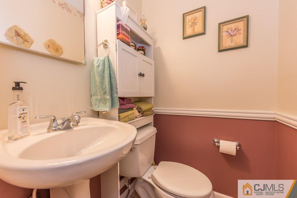 25 South Westfield Road Howell, NJ 07731 - Photo 10 of 22 a bathroom with a sink a toilet and mirror