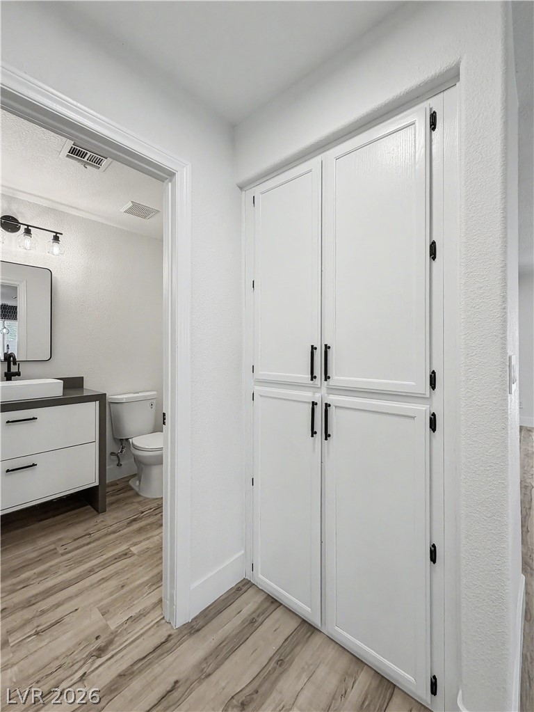8977 Paige Rene Court Las Vegas, NV 89117 - Photo 21 of 31 Smartly designed storage built into the hallway provides functionality and seamless aesthetics.