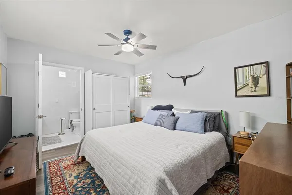 a bedroom with a bed and a chandelier