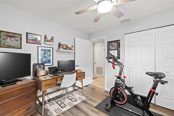 a view of a workspace with furniture and a flat screen tv