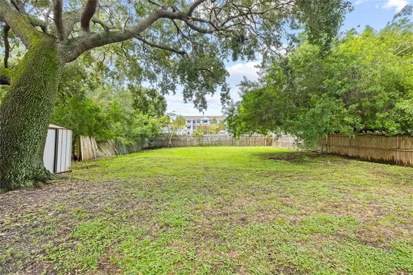 a view of a yard with a tree