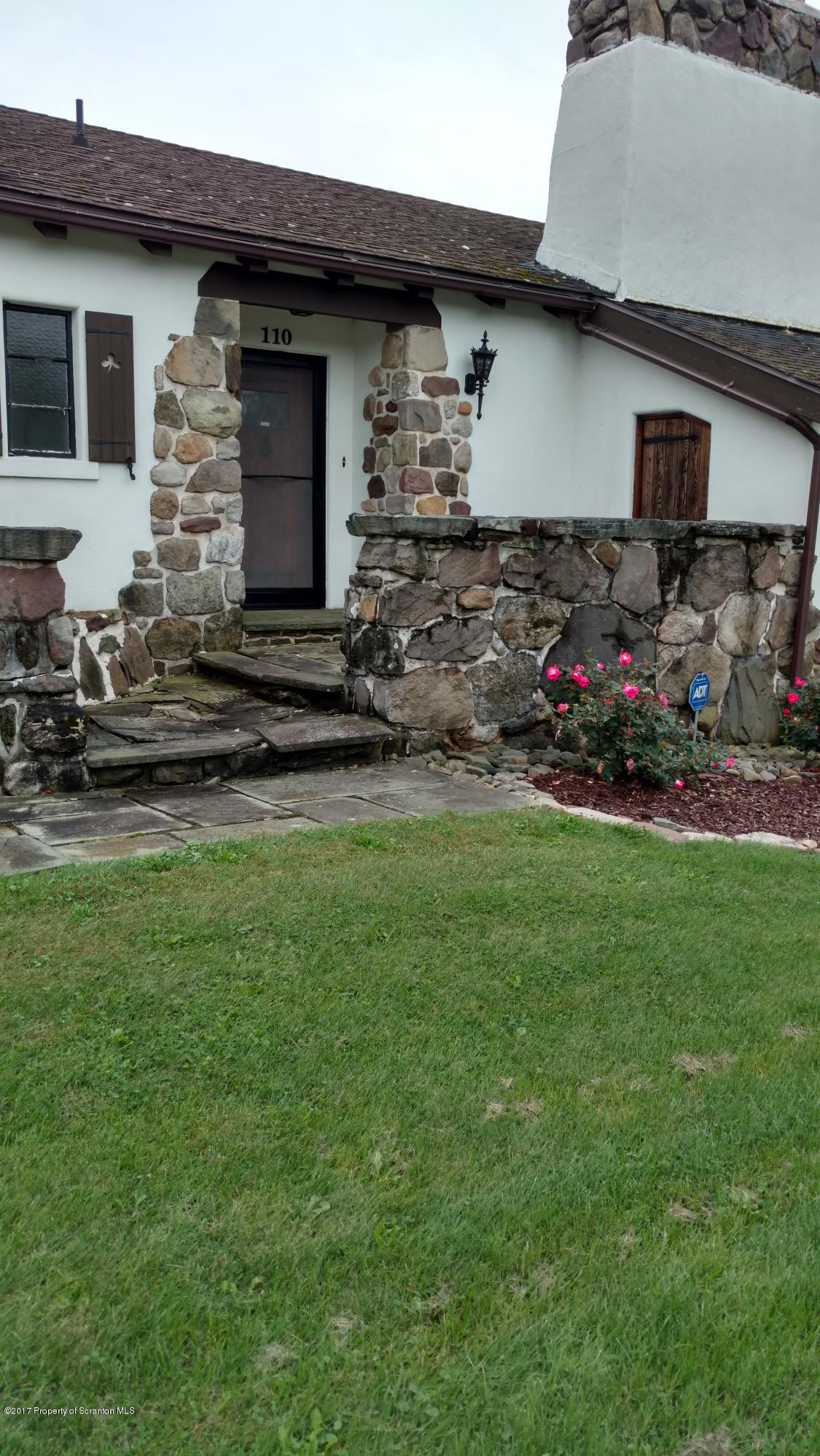 110 Hillcrest Road Moscow, PA 18444 - Photo 3 of 19 a front view of a house with a garden