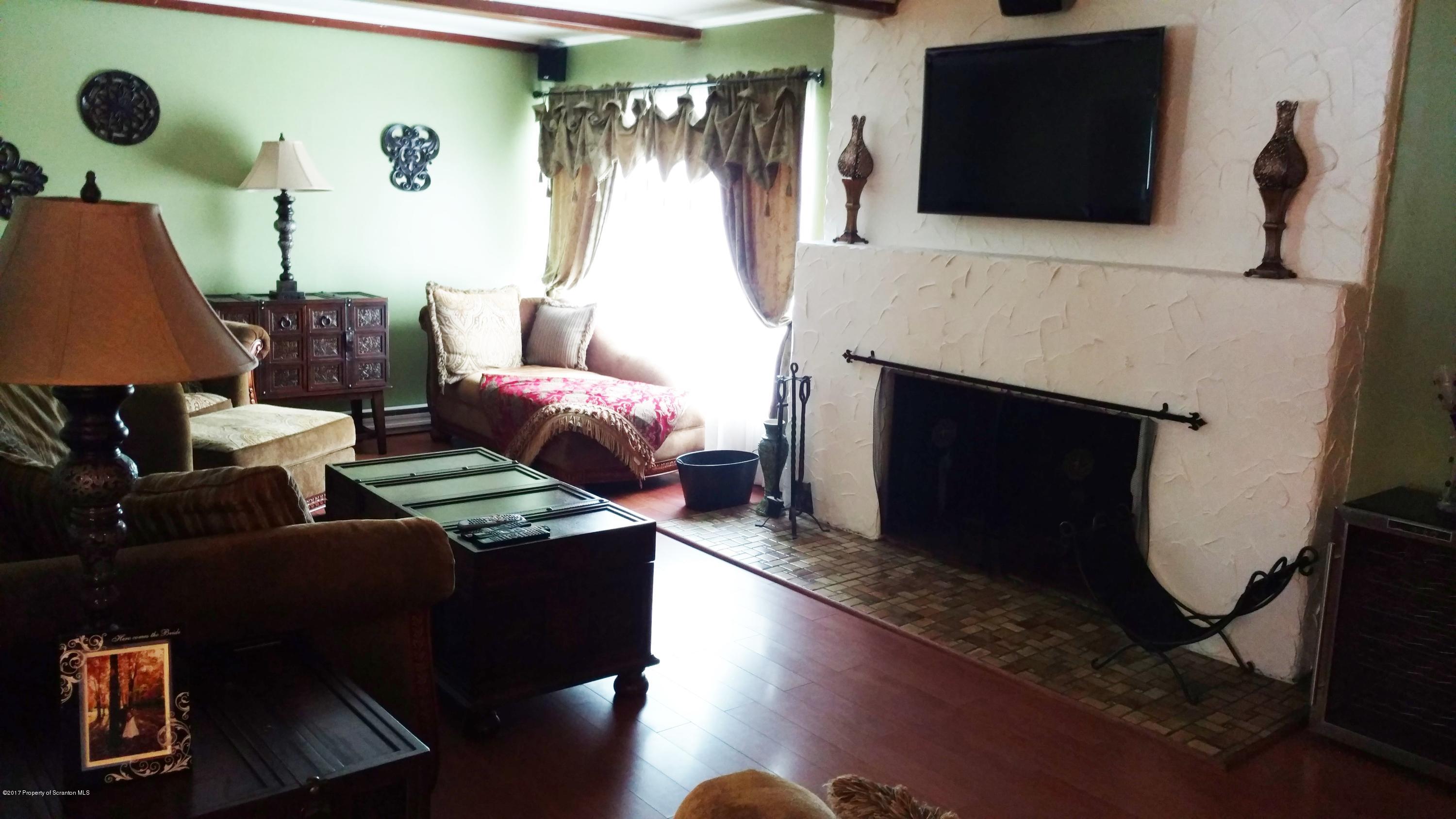 110 Hillcrest Road Moscow, PA 18444 - Photo 7 of 19 a living room with furniture a flat screen tv and a fireplace