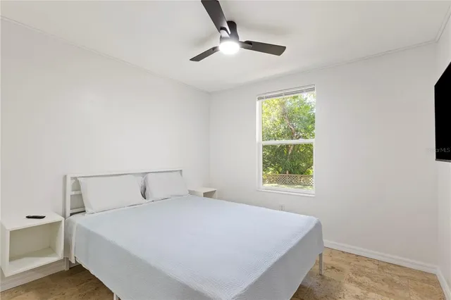 a bedroom with a bed and a window